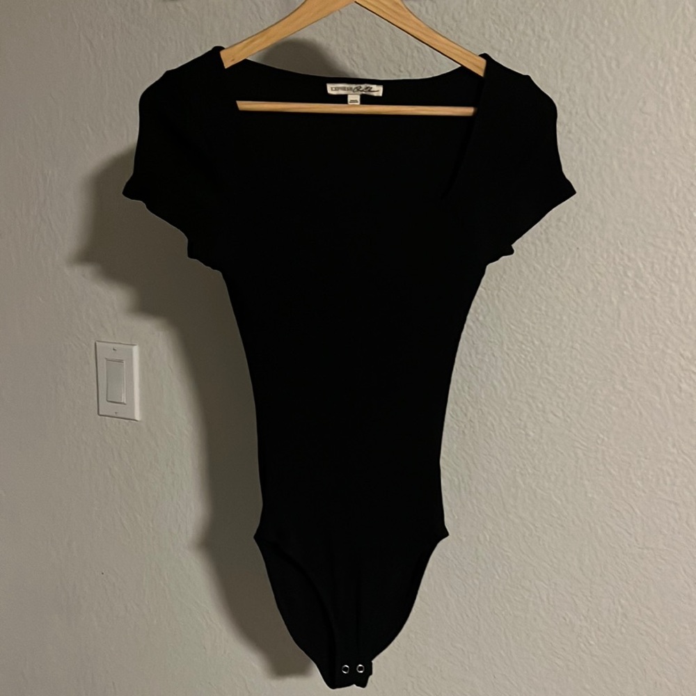 Black, simple bodysuit. Scoop neck. Never worn.